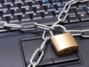 Closeup shot of laptop keyboard secured with chain and padlock